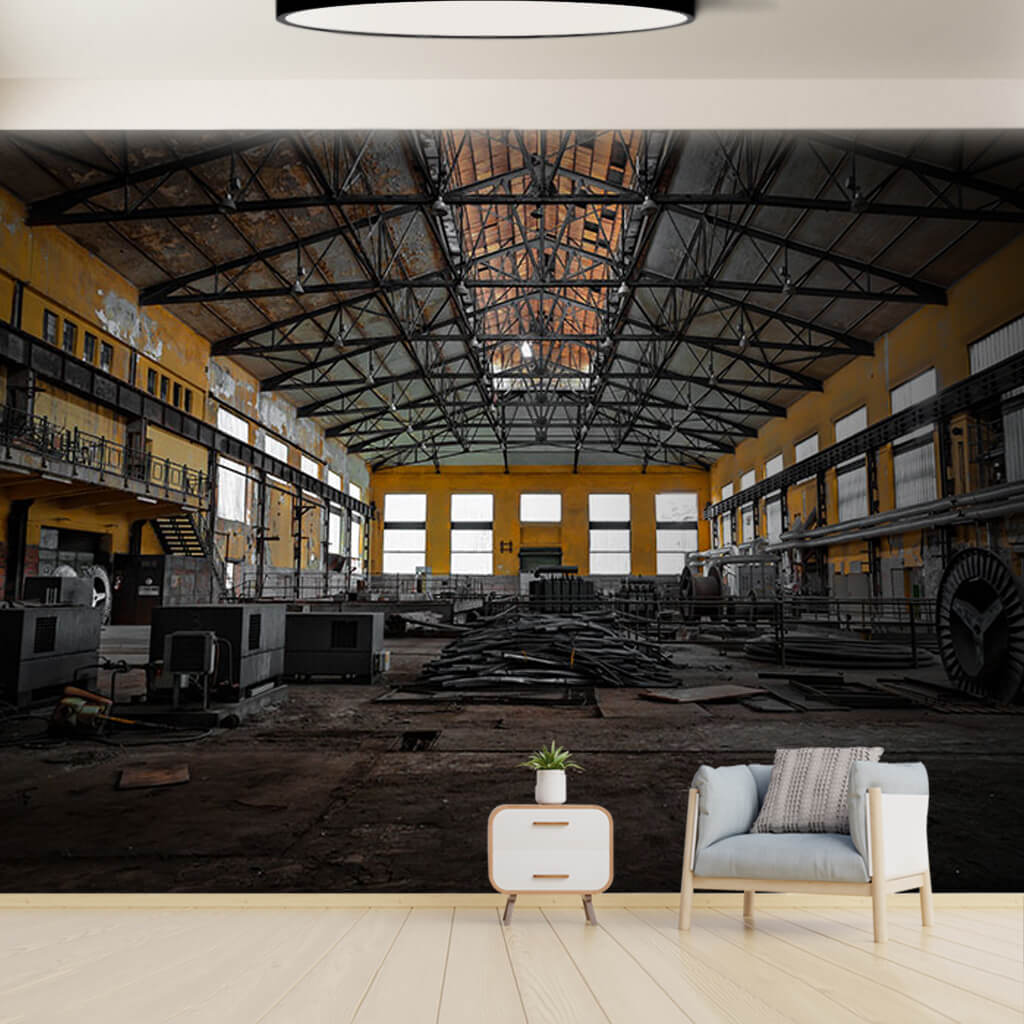 Interior of old metallurgy factory with yellow wall mural