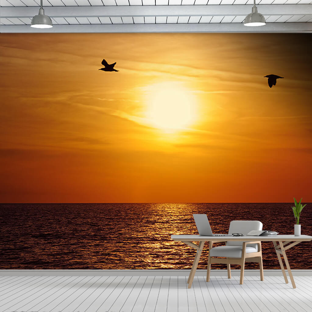 Sea birds flying on ocean and sunset at horizon wall mural