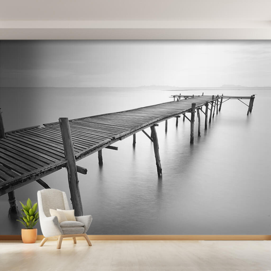 Wooden pier extending into foggy sea black white wall mural
