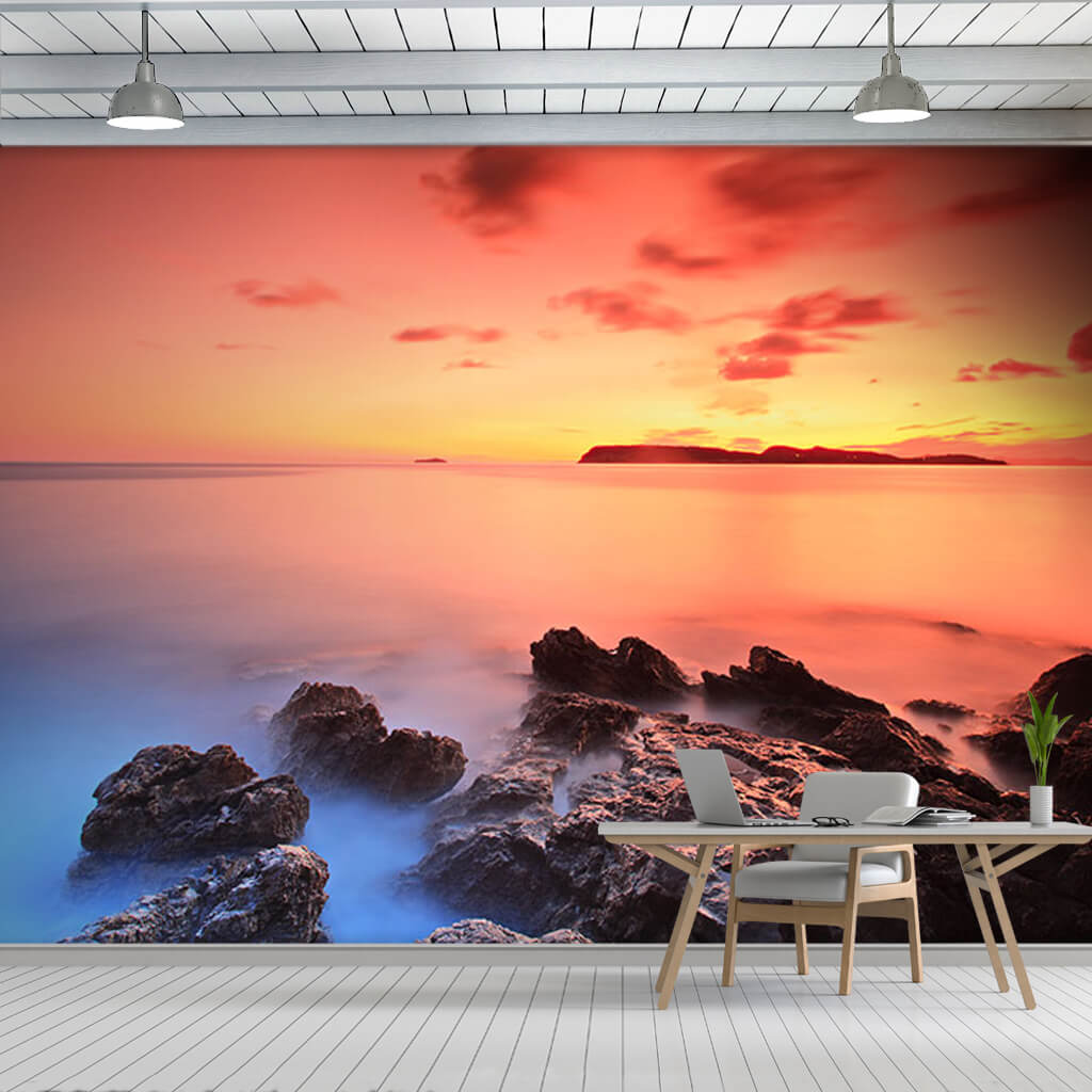 Seascape with foggy rocks and sunset over sea wall mural