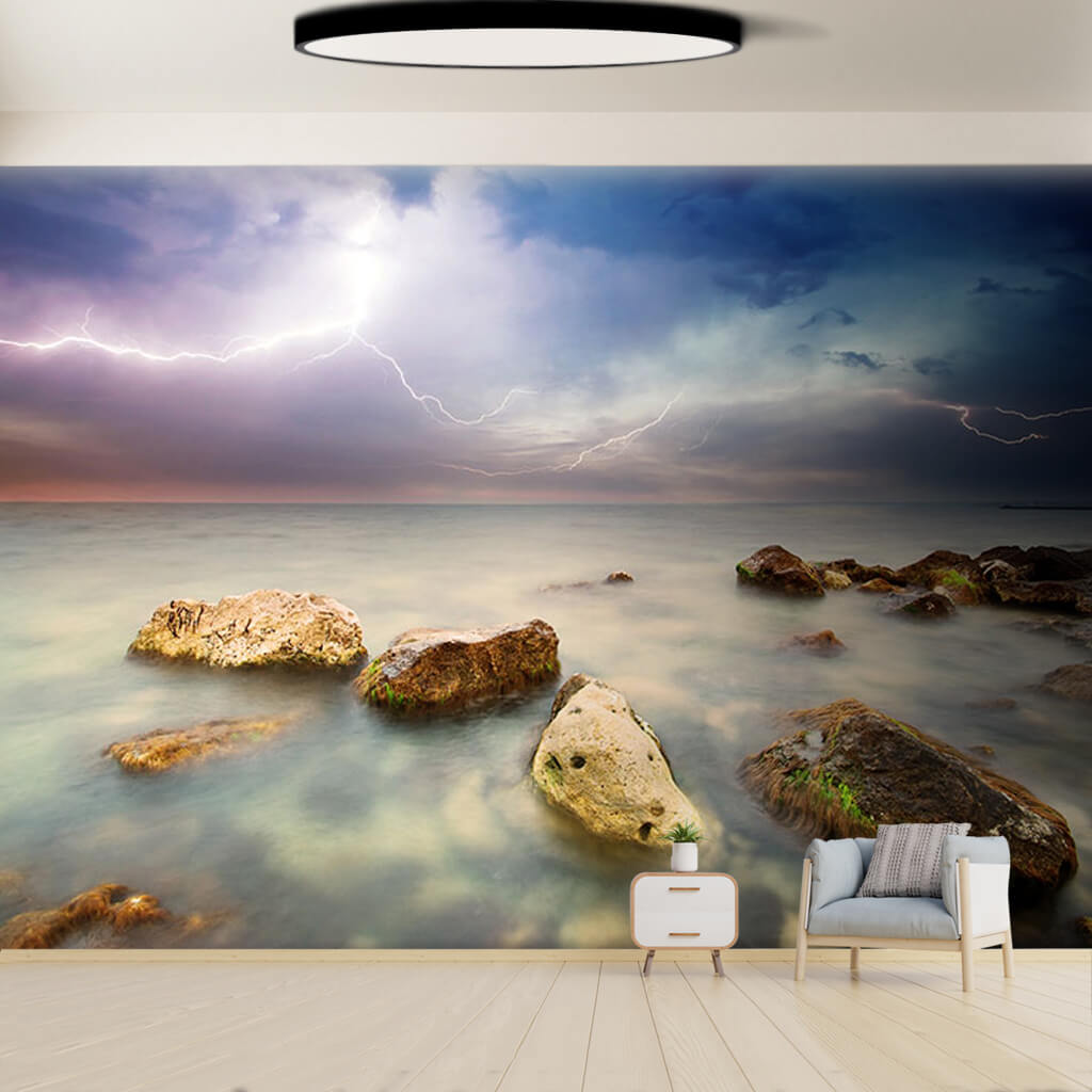 Lightning over the stormy sea and beach rocks wall mural