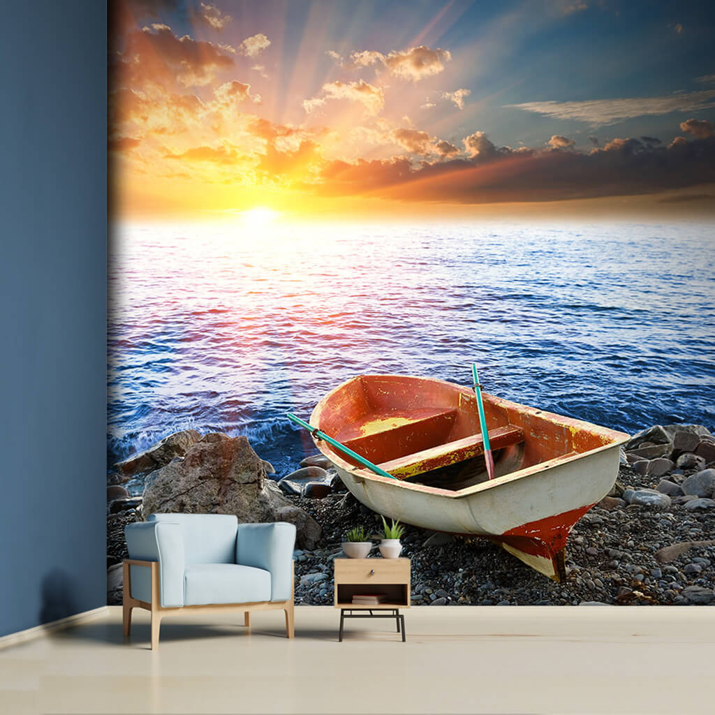 Lonely old kayak and sunset on the sea coast wall mural
