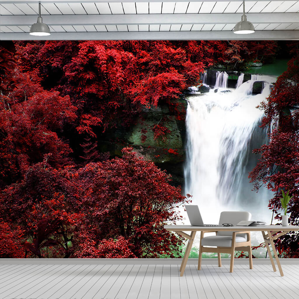 Waterfall flowing through red leafy autumn forest wall mural